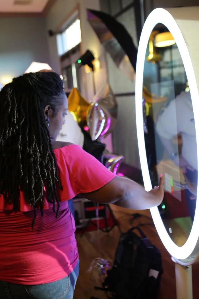 woman viewing a photo booth for sale