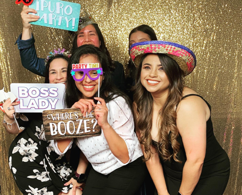 Party guests using photo booth with props at an event