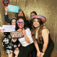 Party guests using photo booth with props at an event
