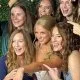 Large-group-of-friends-with-bride-smiling-and-posing-at-a-photo-booth.-Event-and-wedding-services