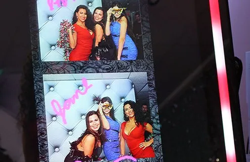A photo of women on a photo booth screen that is ready to print